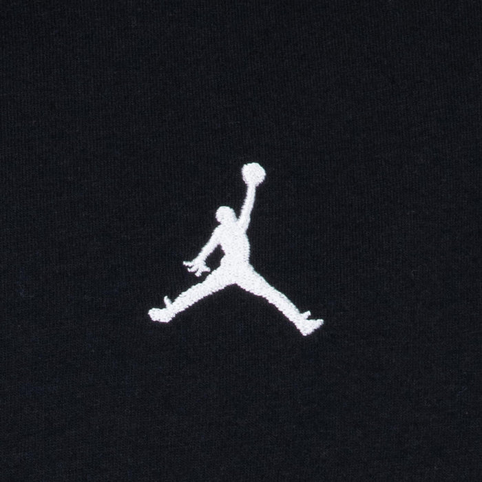 Close-up of white Jumpman embroidered logo on black youth t-shirt