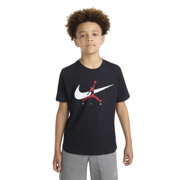 Black youth T-shirt on model, white swoosh and red Jumpman logo at center chest