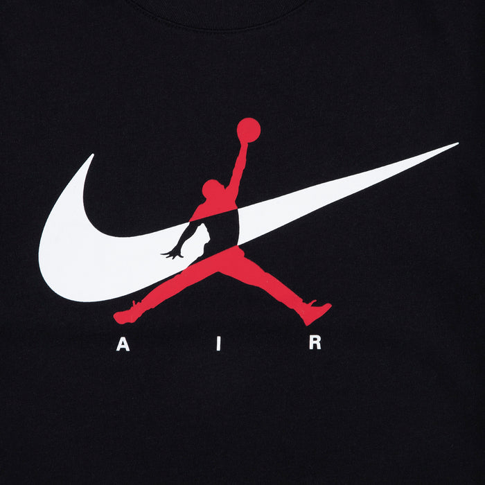 Black youth T-shirt close-up of white Nike swoosh and red Jumpman silhouette graphic