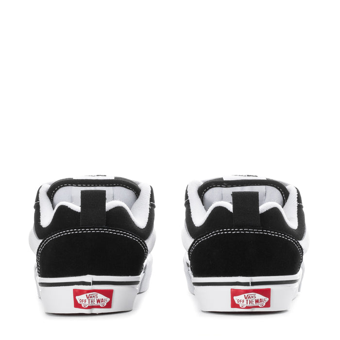 Kids black-and-white low-top skate shoes with Vans 'Off The Wall' heel label.
