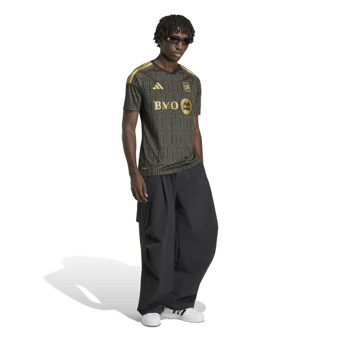 Black men's replica home jersey with gold geometric print and BMO logo, side view