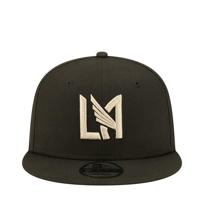Dark baseball cap with white and gold LA-style monogram logo on front
