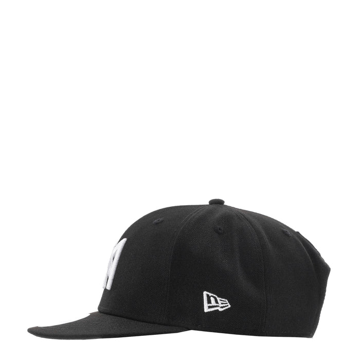 Black baseball cap with white side emblem and curved brim