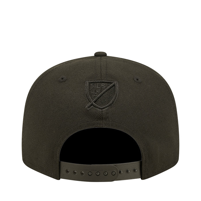 Dark baseball cap with embroidered shield crest logo on back