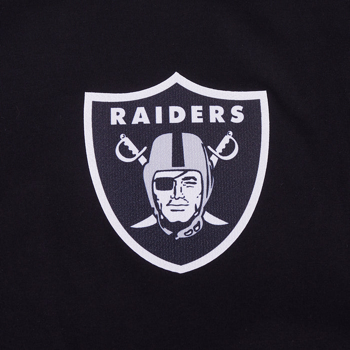 Close-up of white Raiders shield logo on black T-shirt chest