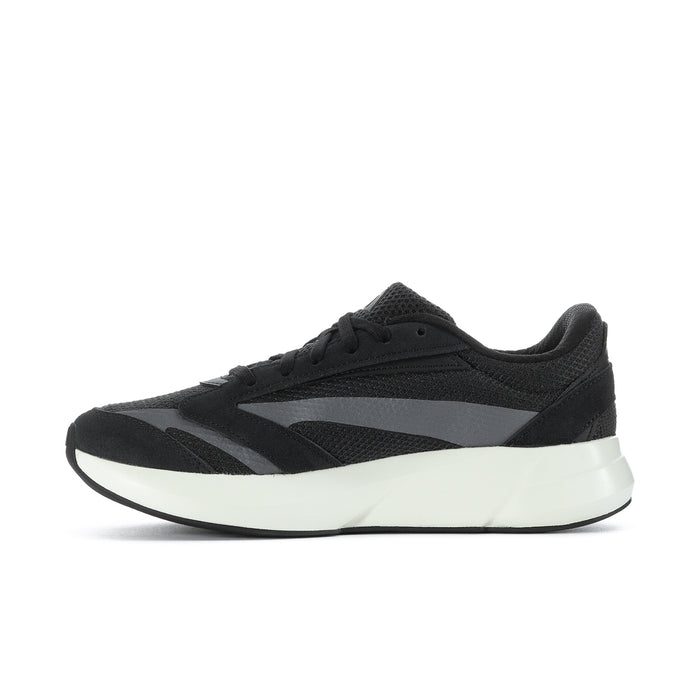Black low-top sneaker with textured paneling, lace-up front and white sole