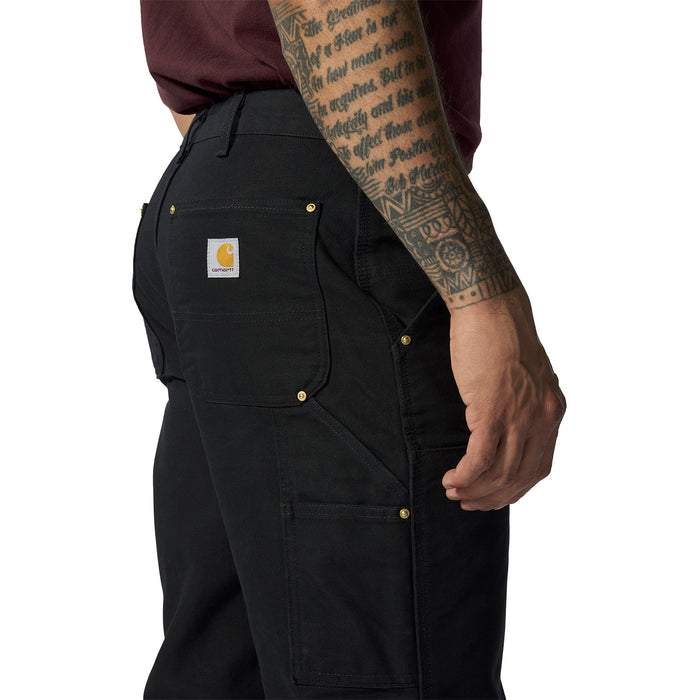 Black work dungaree pants close-up of thigh pocket flap and stitched paneling