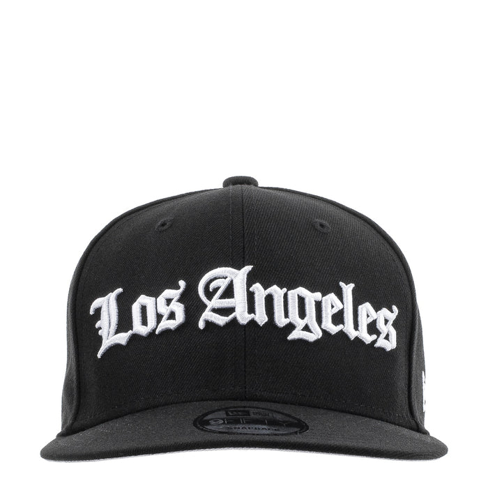 Black baseball cap with white Los Angeles script logo on the front panel