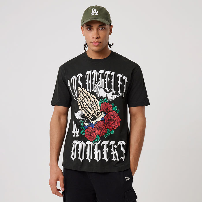 Black graphic T-shirt with gothic-style lettering, hand artwork, and red roses.
