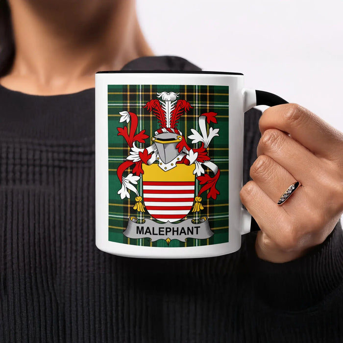 White mug with Malephant family crest on green tartan background.