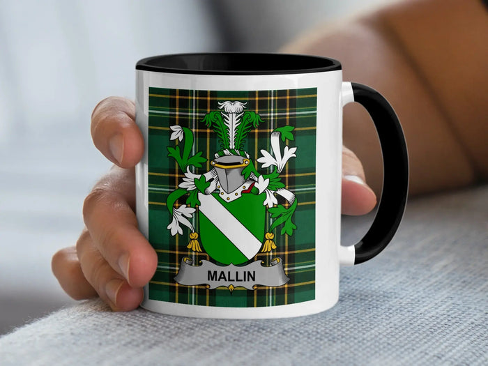 White mug with black rim, featuring a green plaid pattern and the surname "Mallin" in a coat of arms.