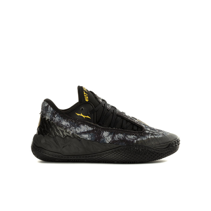 Youth black low-top sneaker with lace-up front and textured side panels, yellow logo