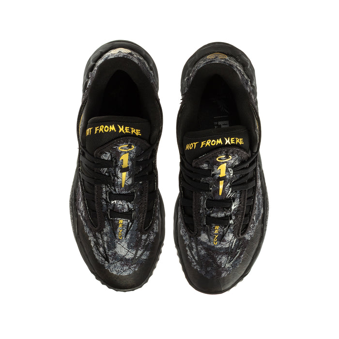 Youth black lace-up sneaker pair, front view, yellow logo print along inner tongue