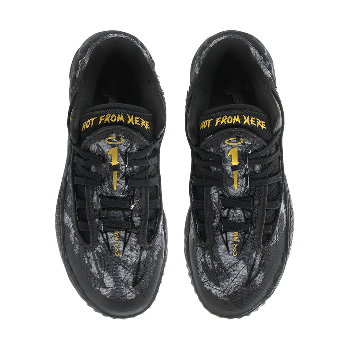 Men's sneakers tongue and lace area with yellow graphic text, dark black upper