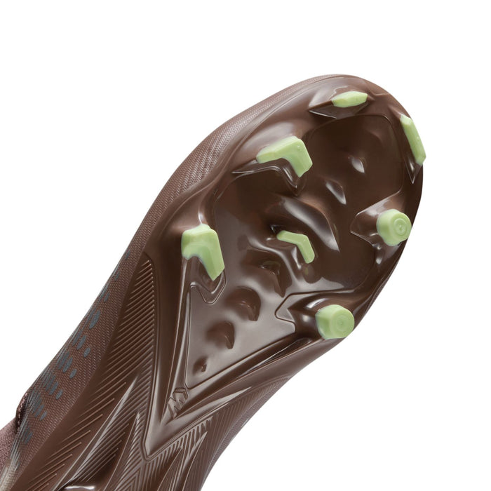 Youth plum soccer cleat sole detail with molded studs and green traction accents
