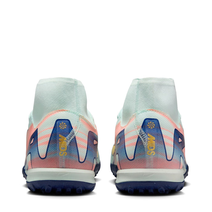 Men's turf cleats heel view in light mint with blue heel logo and pink accents