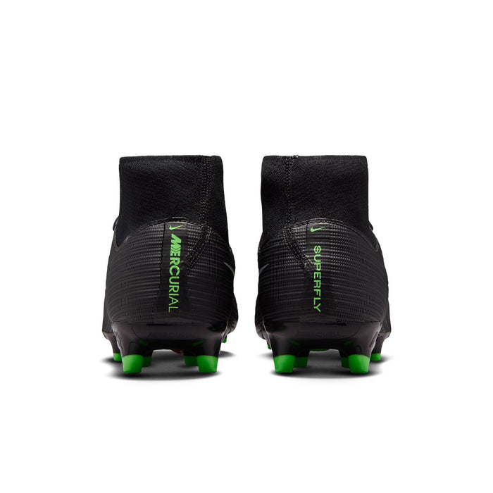 Back view of black mens soccer cleats with neon green heel branding and studs