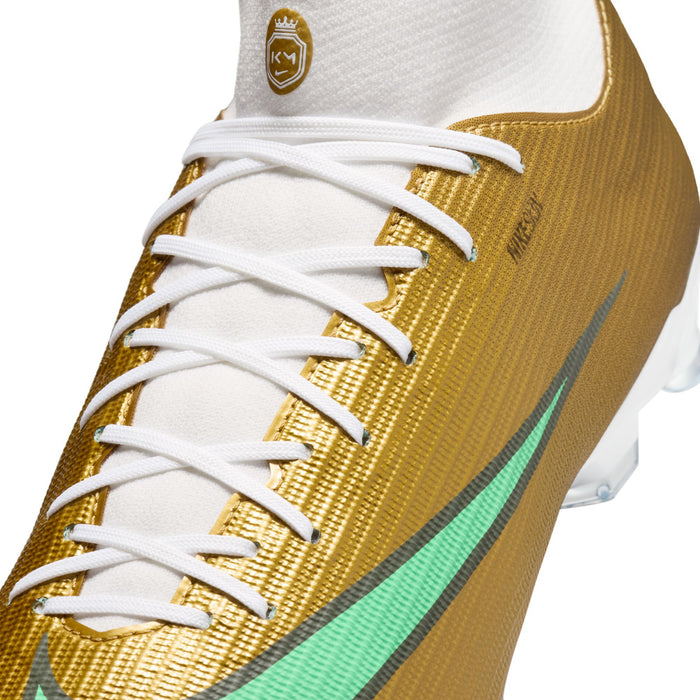 Gold upper soccer cleat with white laces and teal swoosh detail