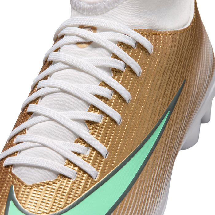Youth soccer cleat close-up: gold mesh upper, white laces, green swoosh detail.