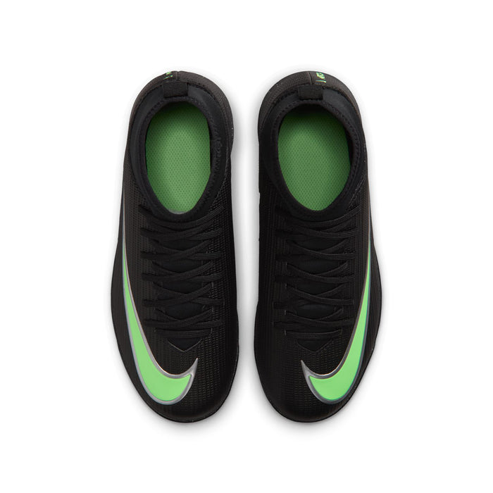 Youth soccer cleats pair with black uppers and bright neon green lining