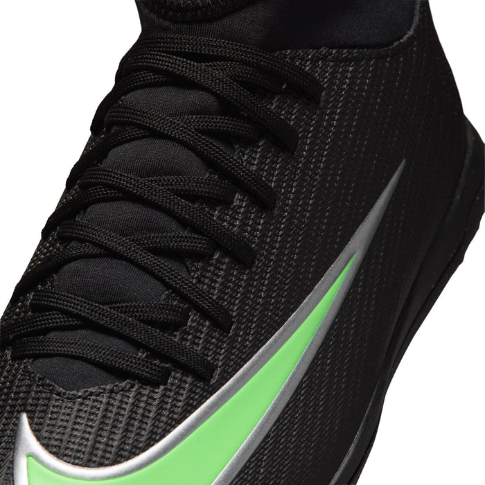 Youth cleat upper close-up with black laces and neon green Swoosh