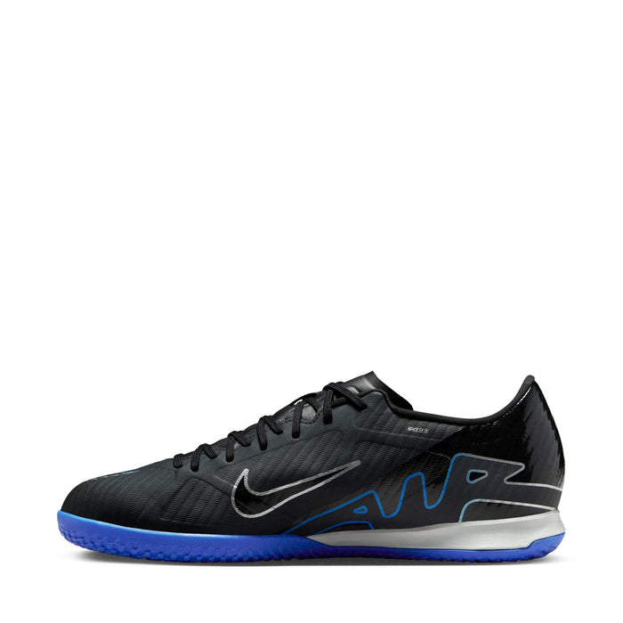 Black lace-up soccer shoes with swoosh and blue graphic accents, low-cut profile