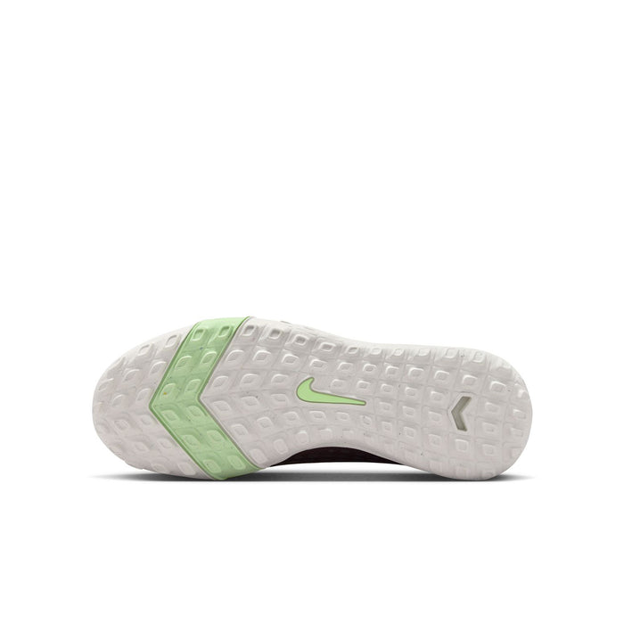 Outsole view of youth plum KM TF soccer cleats with green traction studs