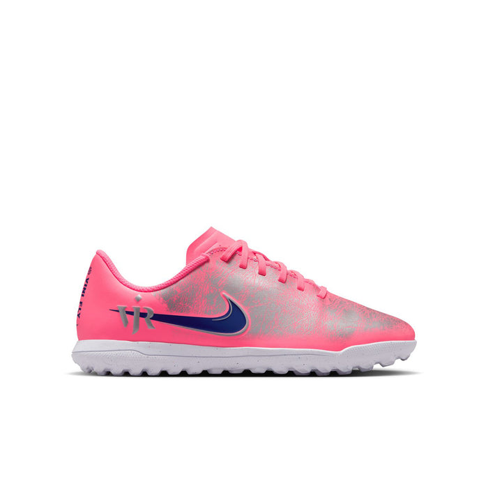 Youth pink turf soccer shoes with blue Nike swoosh and lace-up design