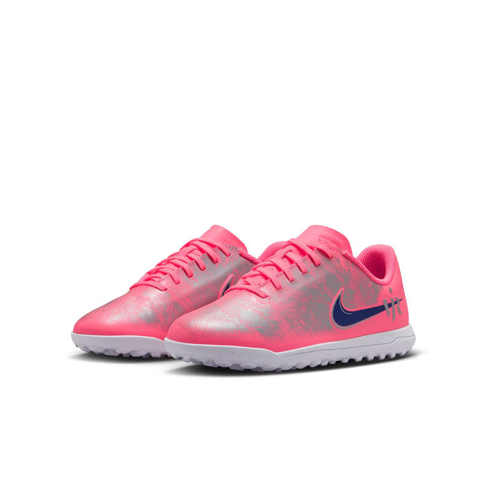 Youth pink turf soccer shoes, side view with blue swoosh and white traction sole