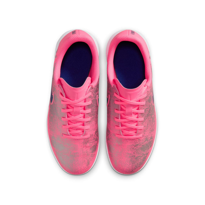 Youth pink soccer shoes with textured upper, lace-up closure, navy interior