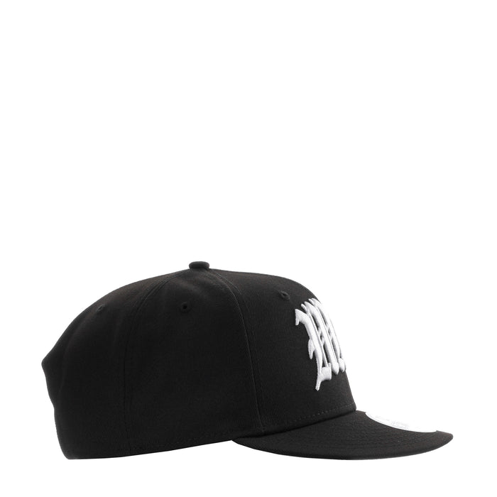 Black baseball cap side view with white stitched emblem on crown