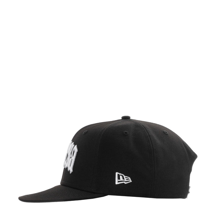 Black baseball cap front with small white New Era flag logo
