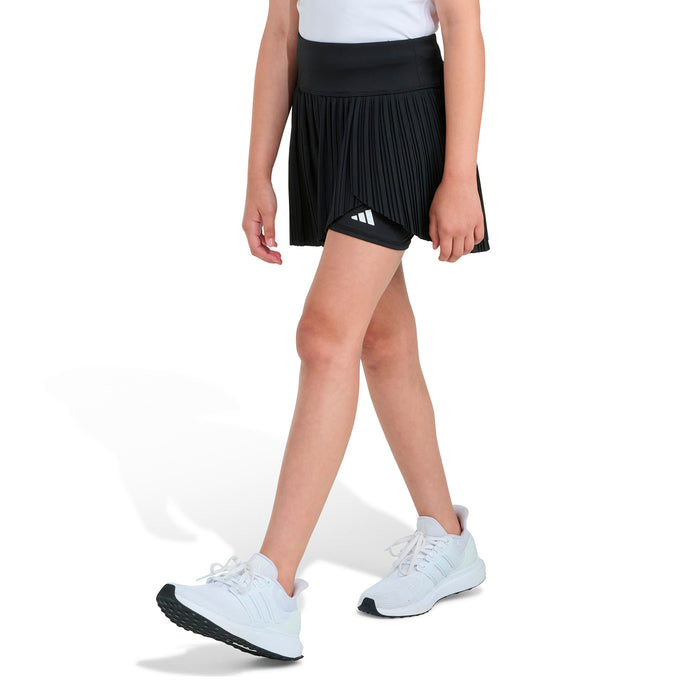 Youth black pleated skort with built-in shorts and adidas logo, front view