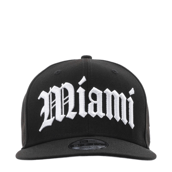 Black baseball cap with large white Miami graphic on the front
