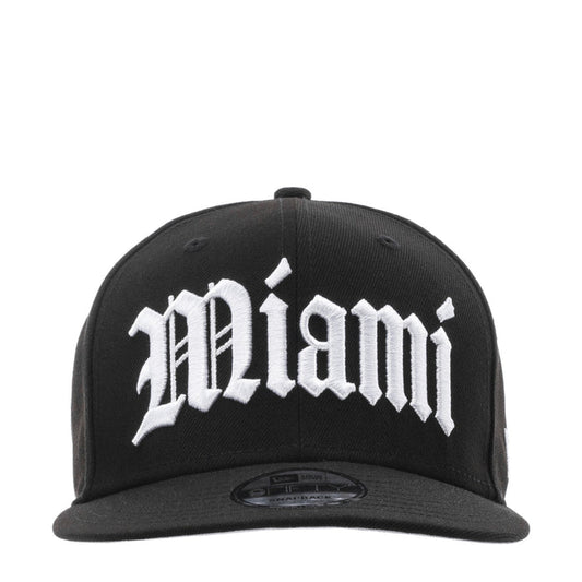 Black baseball cap with large white Miami graphic on the front