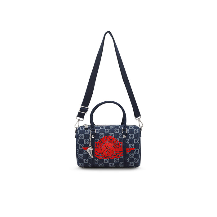 Dark indigo mini duffle bag with red emblem, zip top, and adjustable shoulder strap