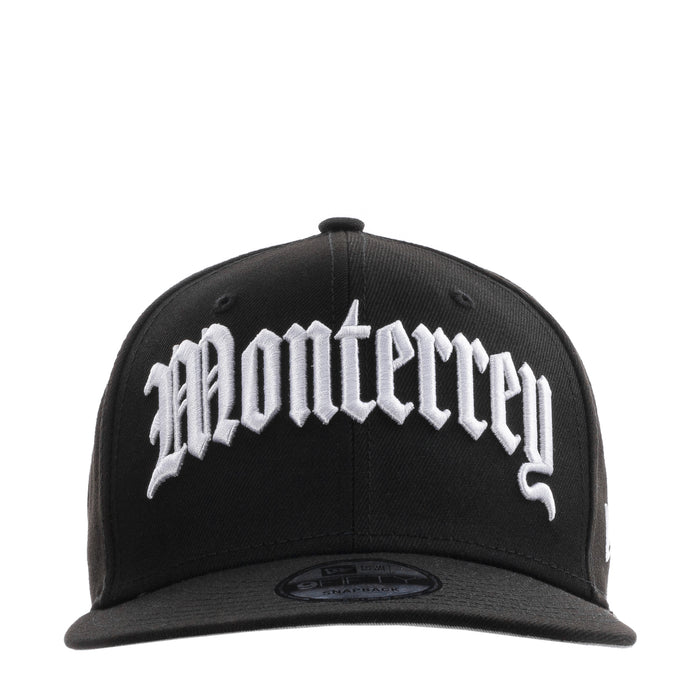 Black baseball cap with large white script front logo and curved brim