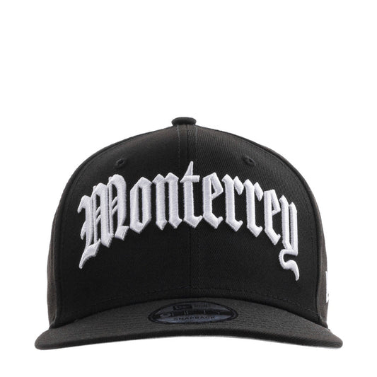 Black baseball cap with large white script front logo and curved brim