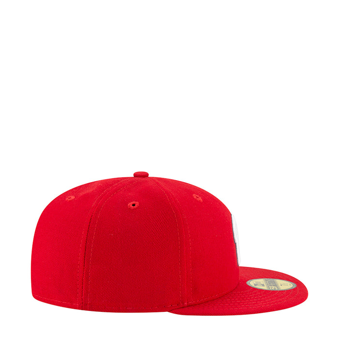 Red baseball cap with curved brim and stitched panels, side view
