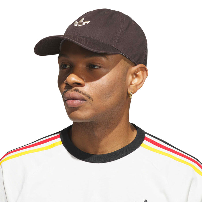 Brown trefoil logo strapback cap worn on head, curved brim