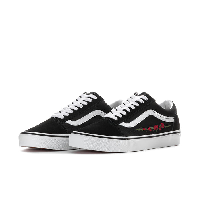 Men's low-top sneakers, black uppers with white wavy stripe and rose embroidery detail.