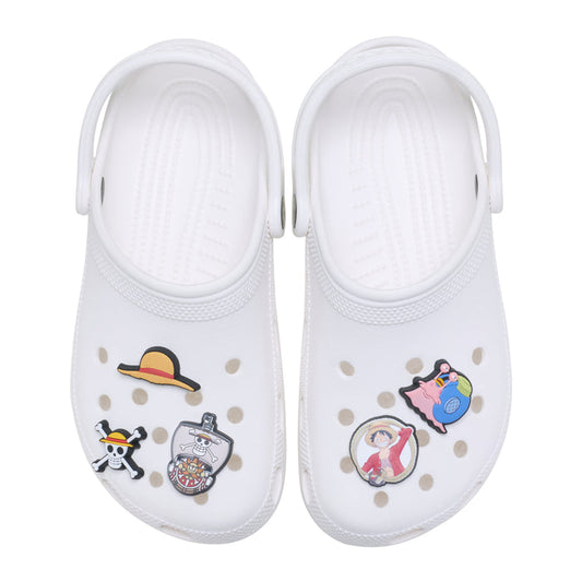 White Crocs-style shoe charms with cartoon character figures, multi-color, pair view