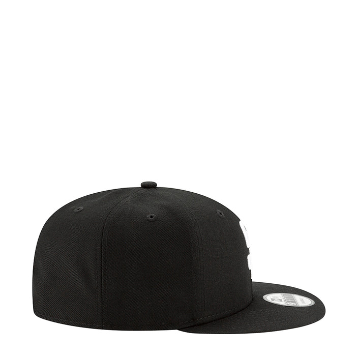 Black baseball cap, side view with curved brim and stitch panels