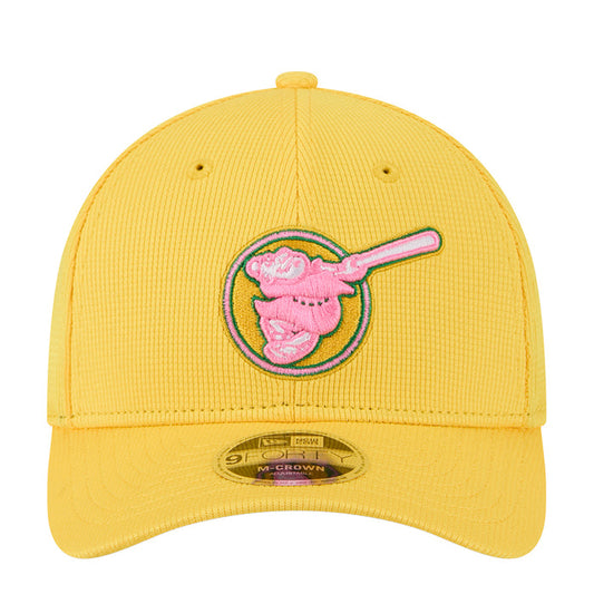 Yellow baseball cap with pink embroidered logo and M-Crown patch