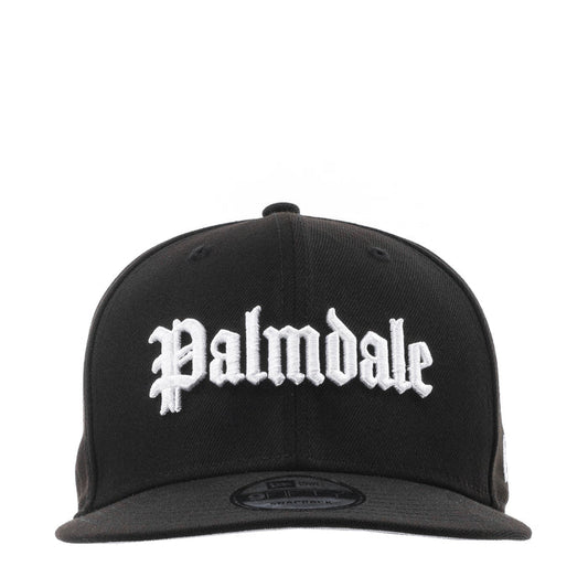 Black baseball cap with white script logo on the front and flat brim