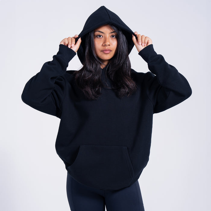 Women's black fleece pullover hoodie with hood up and kangaroo pocket