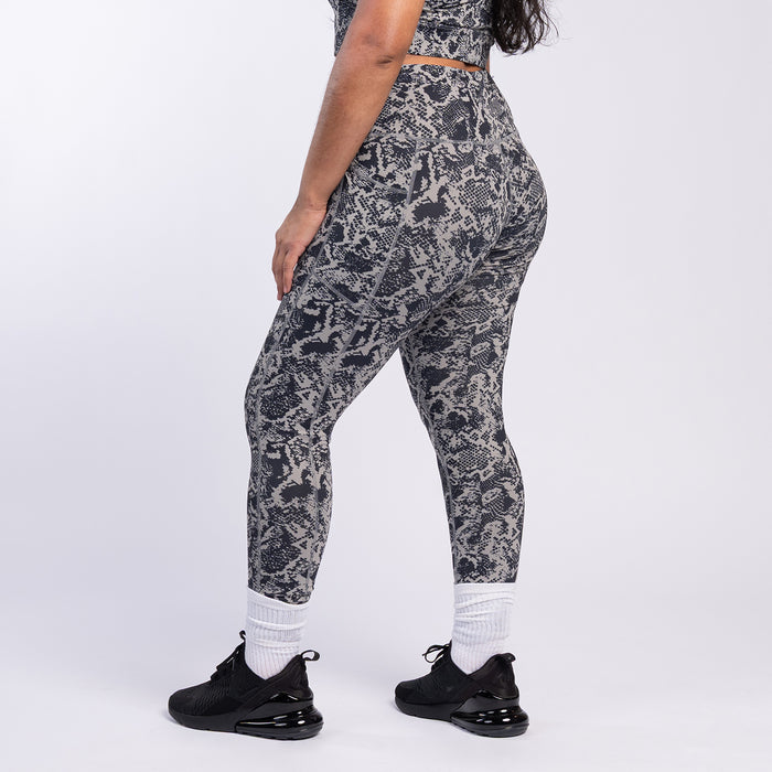 Front view of snake print high-waist leggings, dark gray and black
