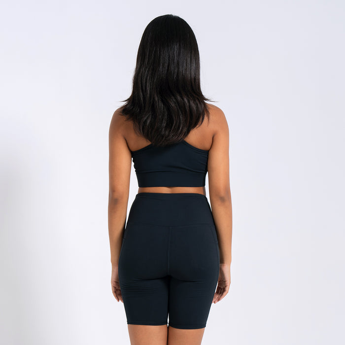Women's black sports bra back view with crisscross racerback strap detail