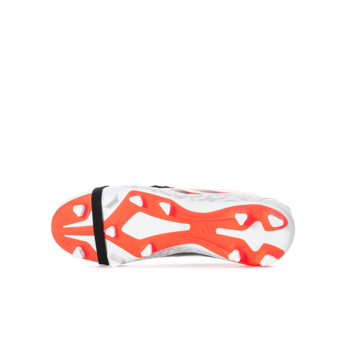 Youth soccer cleat sole view: white studs with orange traction pattern and black strap