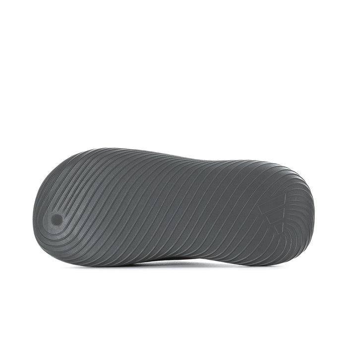Grey slide sandal outsole with circular traction pattern